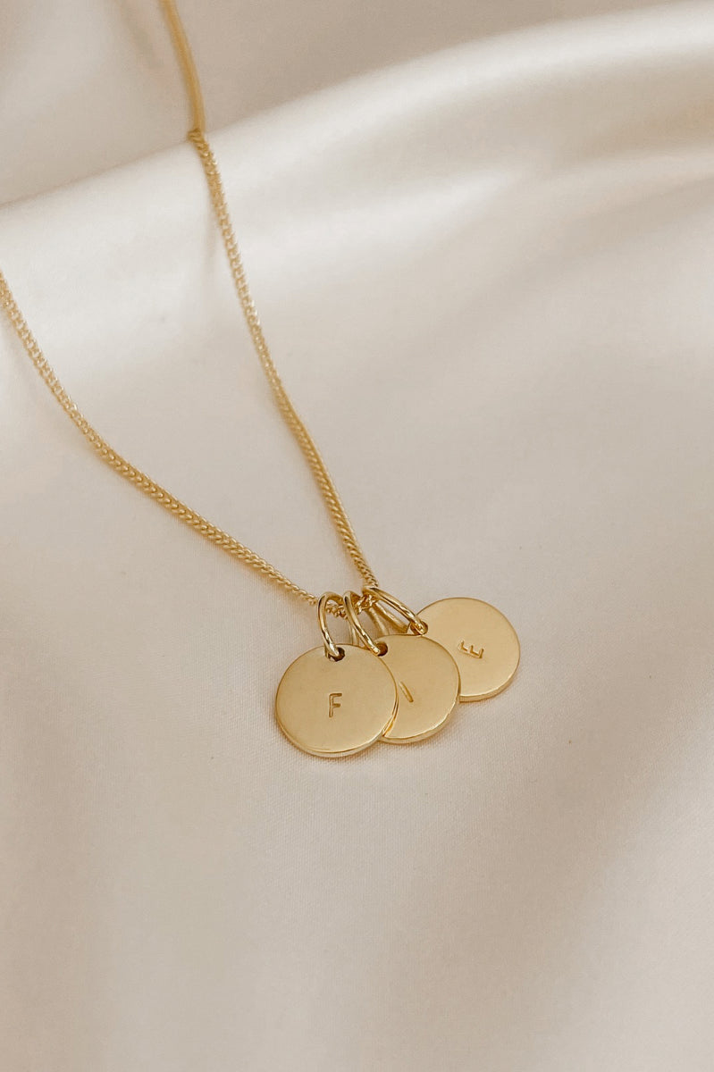 A fine curb chain with three personalised initial pendants (10mm)