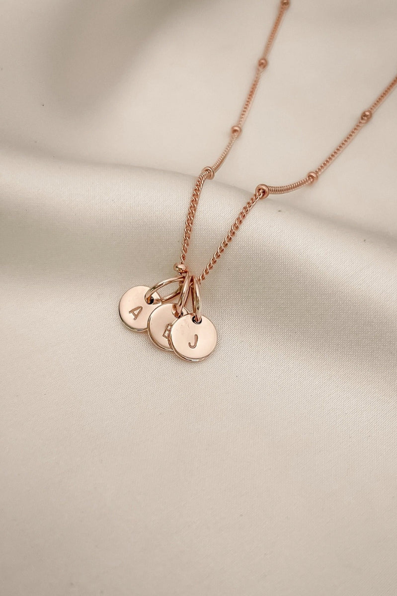 A Rose Gold Petite Personalised Necklace with three solid 9ct Rose Gold initial pendants on a fine ball chain necklace.