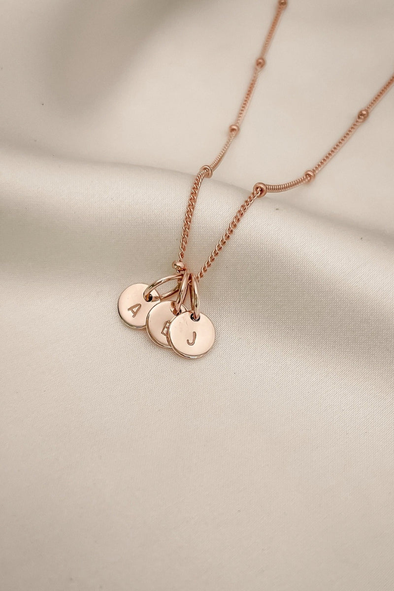 A Rose Gold Petite Personalised Necklace with three solid 9ct Rose Gold initial pendants on a fine ball chain necklace.