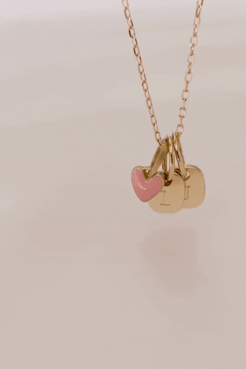 Bluebird co's 9ct solid gold pink heart attached to a solid gold necklace with solid gold initials