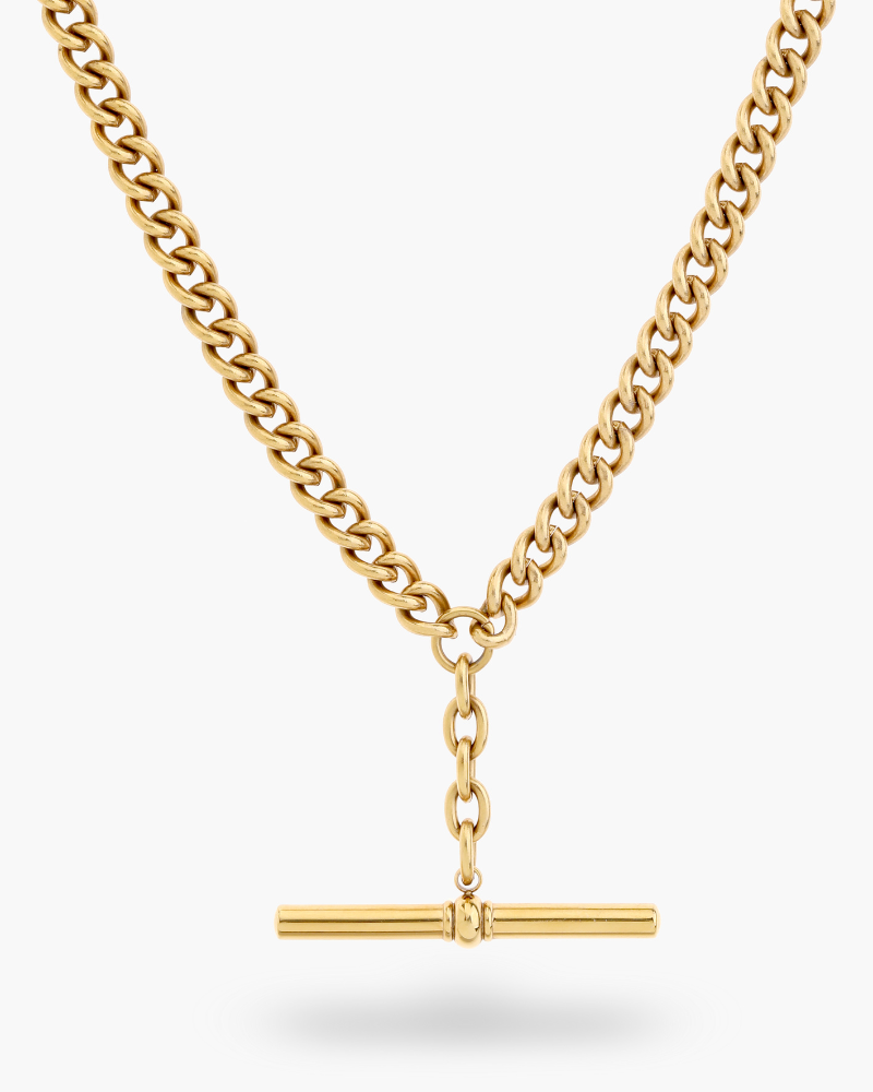 Gold chain necklace with a bar pendant on a white background. The necklace features a bluebird co logo tag.