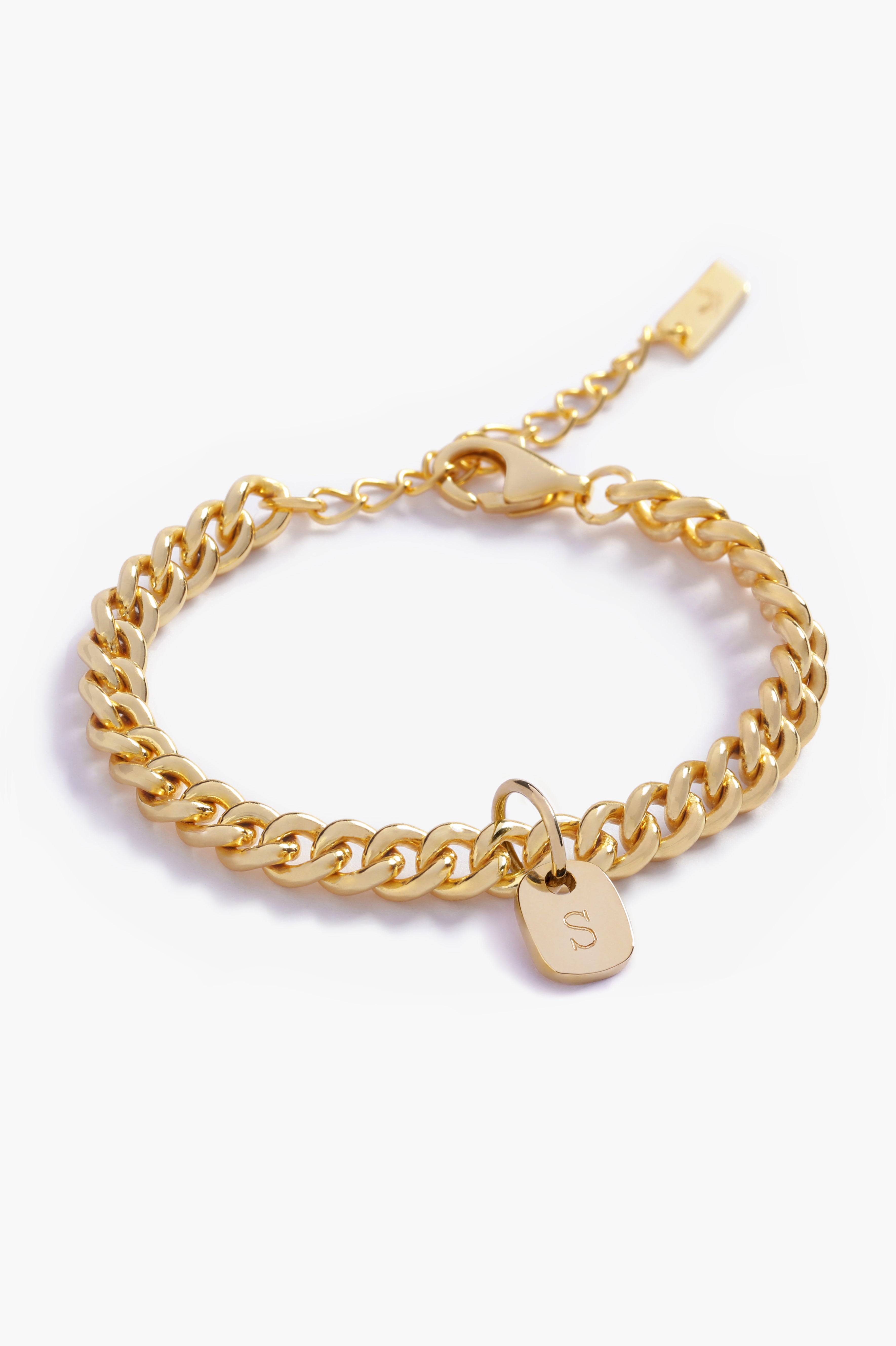 A gold bracelet with personalised solid gold initial pendant, beautifully displayed on a white background to highlight its craftsmanship by Bluebird Jewellery.