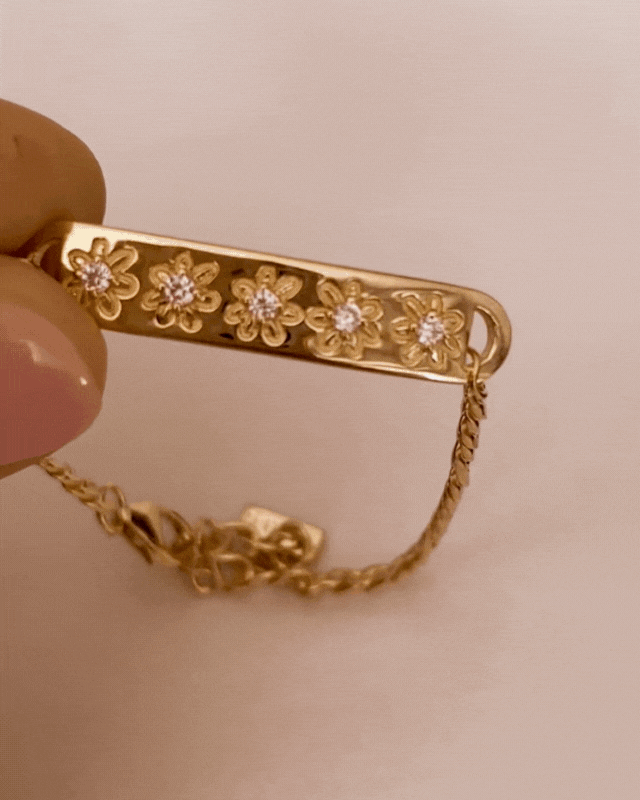 Bluebird Co's daisy bracelet in gold with daisy earrings.