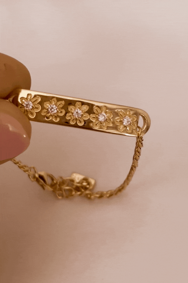 Bluebird Co's daisy bracelet in gold with daisy earrings.