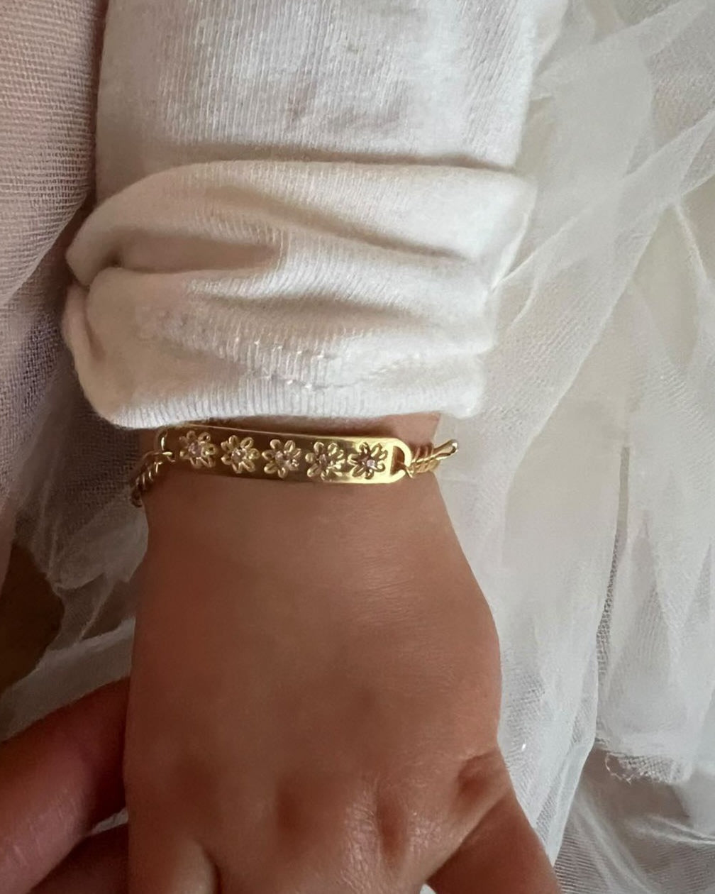 Daisy Bracelet by Bluebird Jewellery in baby size on a young girl's wrist.