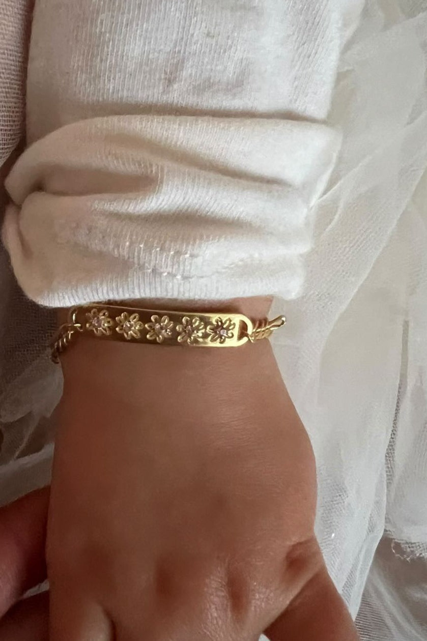 Daisy Bracelet by Bluebird Jewellery in baby size on a young girl's wrist.