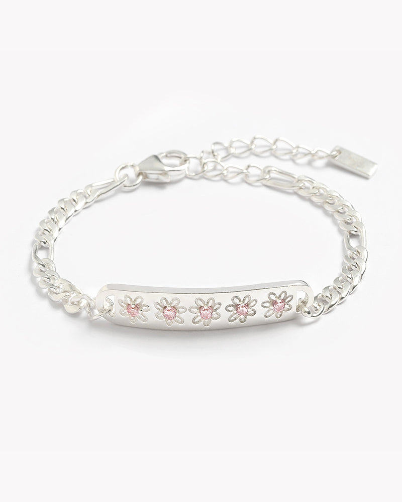 A delicate silver Daisy Bracelet from Bluebird Jewellery, showcasing five daisy motifs with soft pink centres for a charming, floral-inspired look