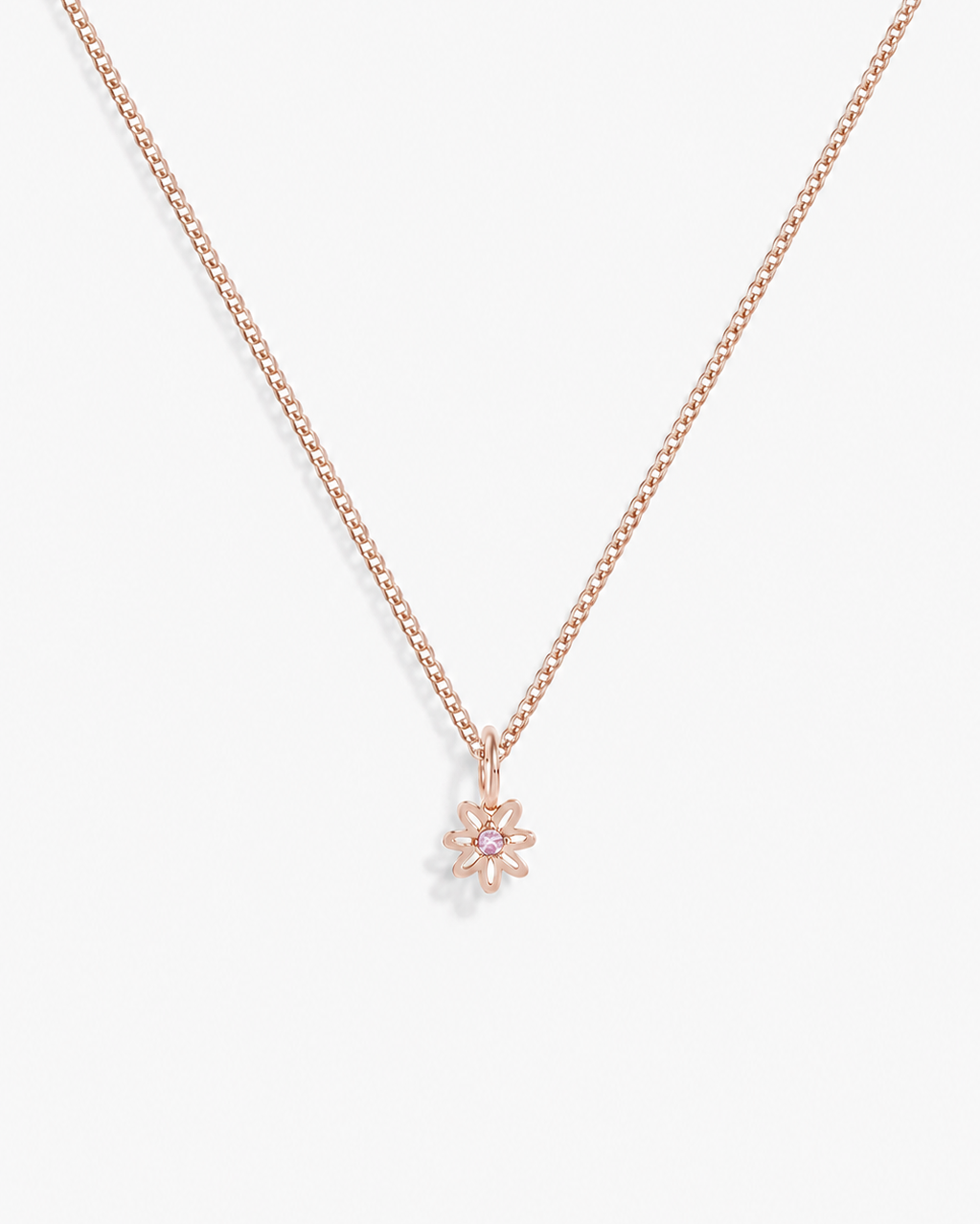 A delicate rose gold chain necklace with a small flower-shaped pendant, displayed against a clean white background.