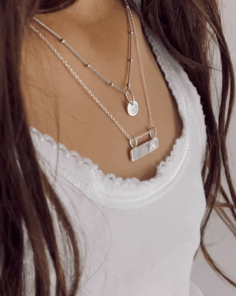 Bluebird Co's darling bar necklace layered with ball chain necklace.