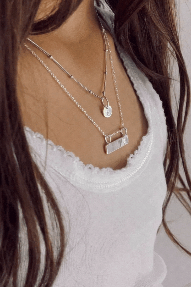 Bluebird Co's darling bar necklace layered with ball chain necklace.