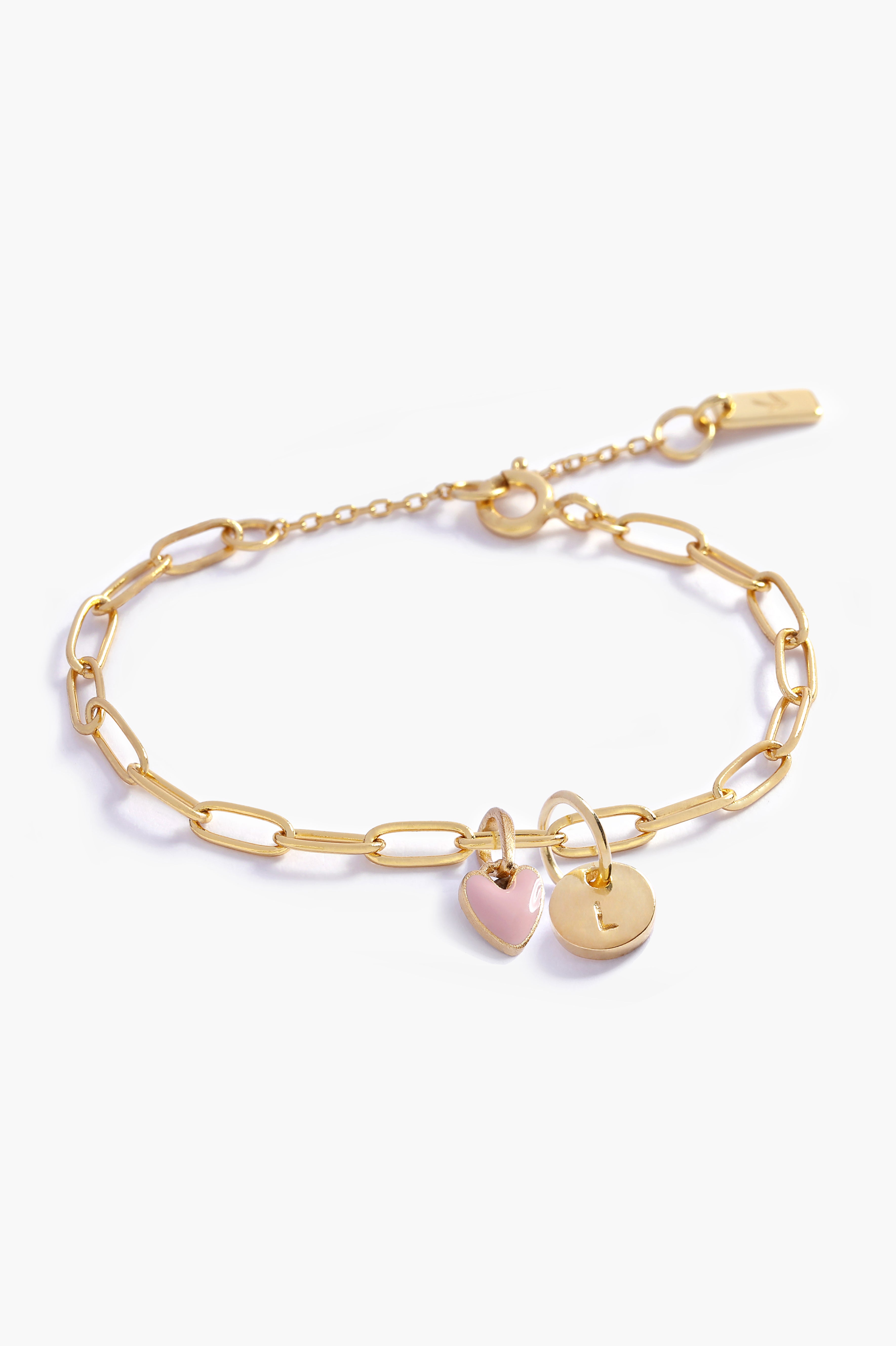 Gold chain bracelet with heart-shaped and round pendants.
