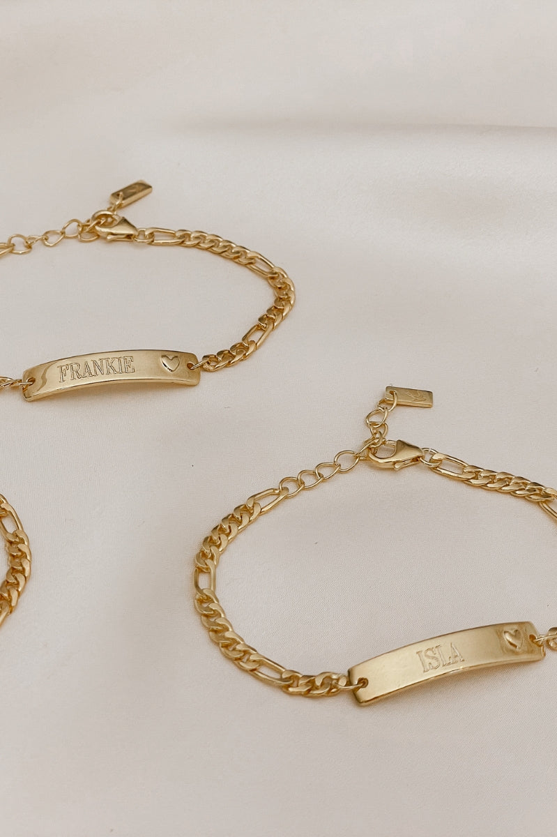Engraved gold bracelets with heart detail, designed as personalised jewellery for babies, children, or adults.