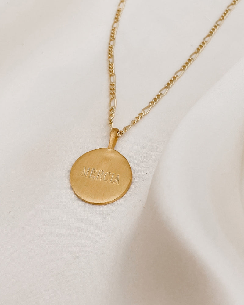 A name is engraved on the front of a Signature necklace pendant.