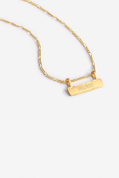 a Signature Bar Necklace with the word BELOVED engraved on the front of the bar pendant.  The necklace features a figaro necklace chain and a raised, textured edge on the bar pendant.