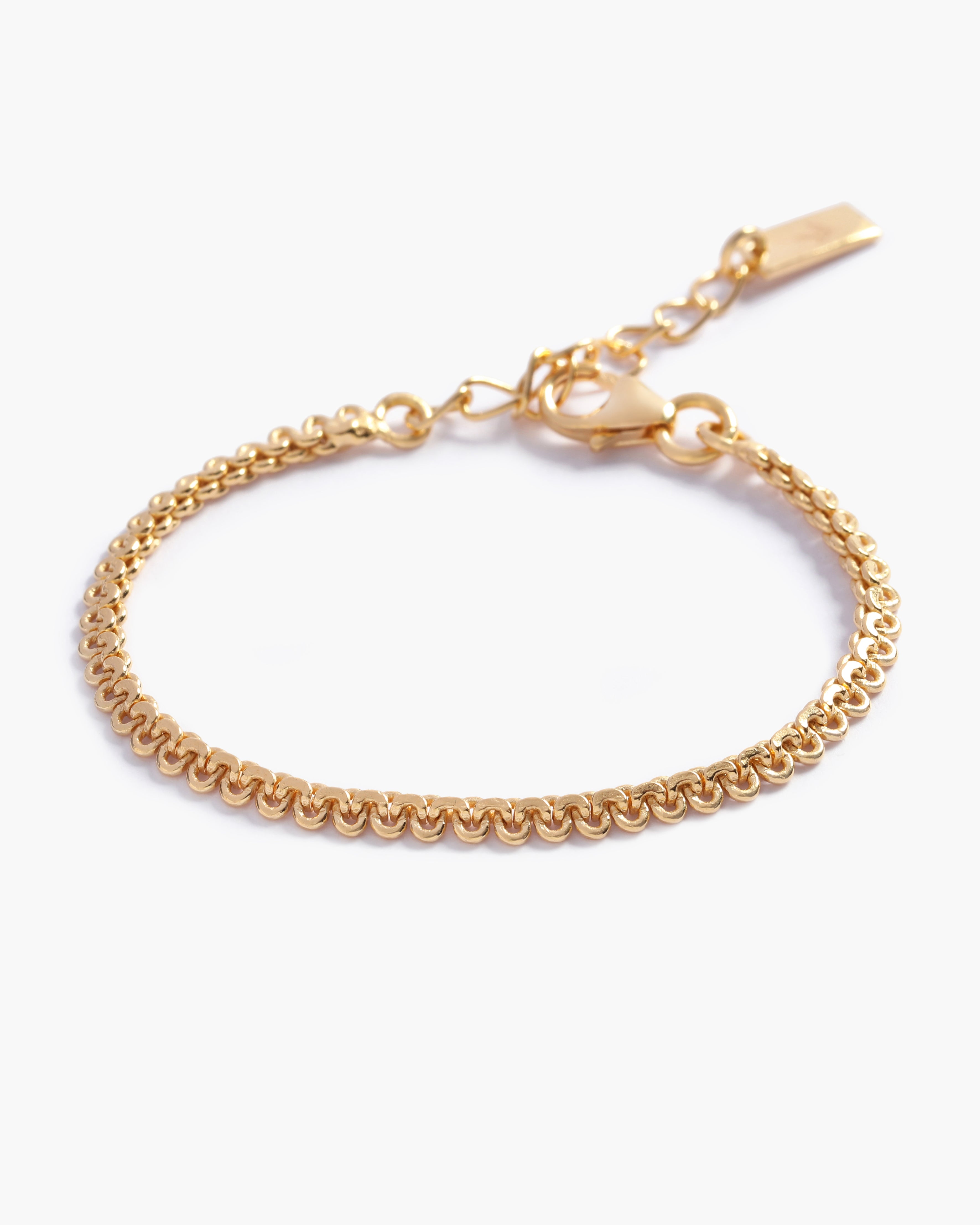 A close-up of The Lace Chain Anklet, an elegant gold bracelet with delicate lace-like detailing and a refined minimalist design by Bluebird Jewellery