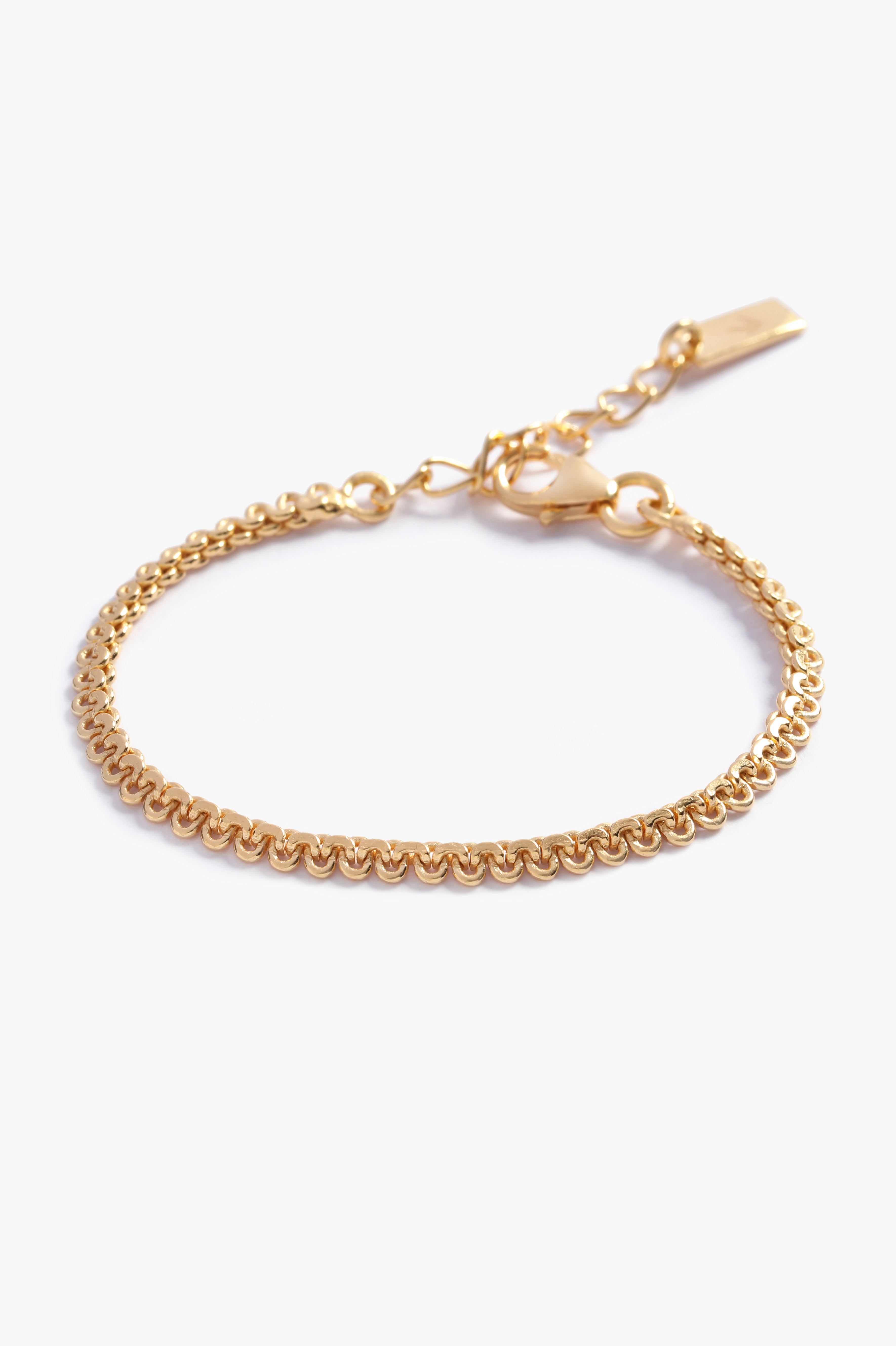 A close-up of The Lace Chain Anklet, an elegant gold bracelet with delicate lace-like detailing and a refined minimalist design by Bluebird Jewellery