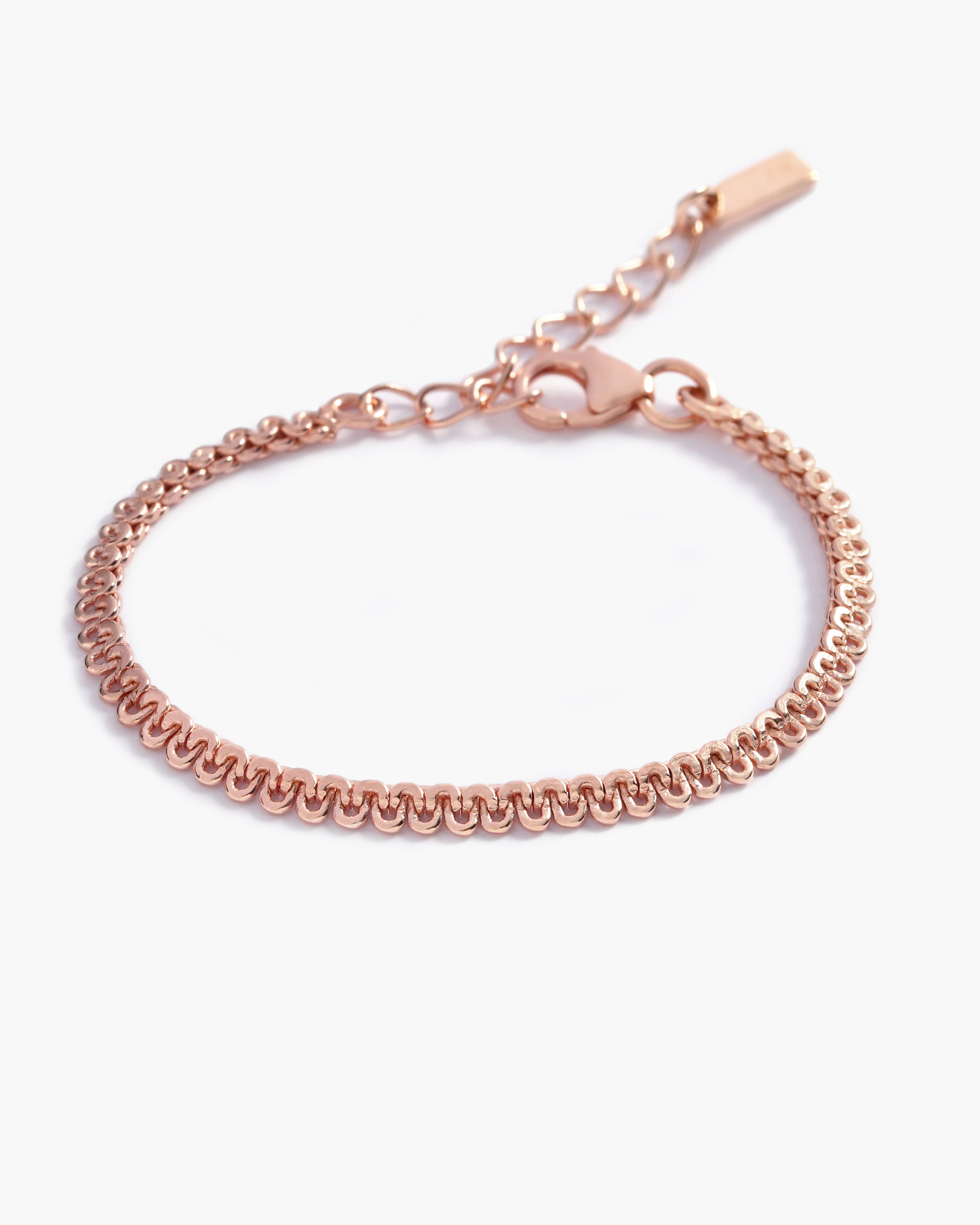 A close-up of The Lace Chain Bracelet, an elegant rose gold bracelet with delicate lace-like detailing and a refined minimalist design by Bluebird Jewellery.