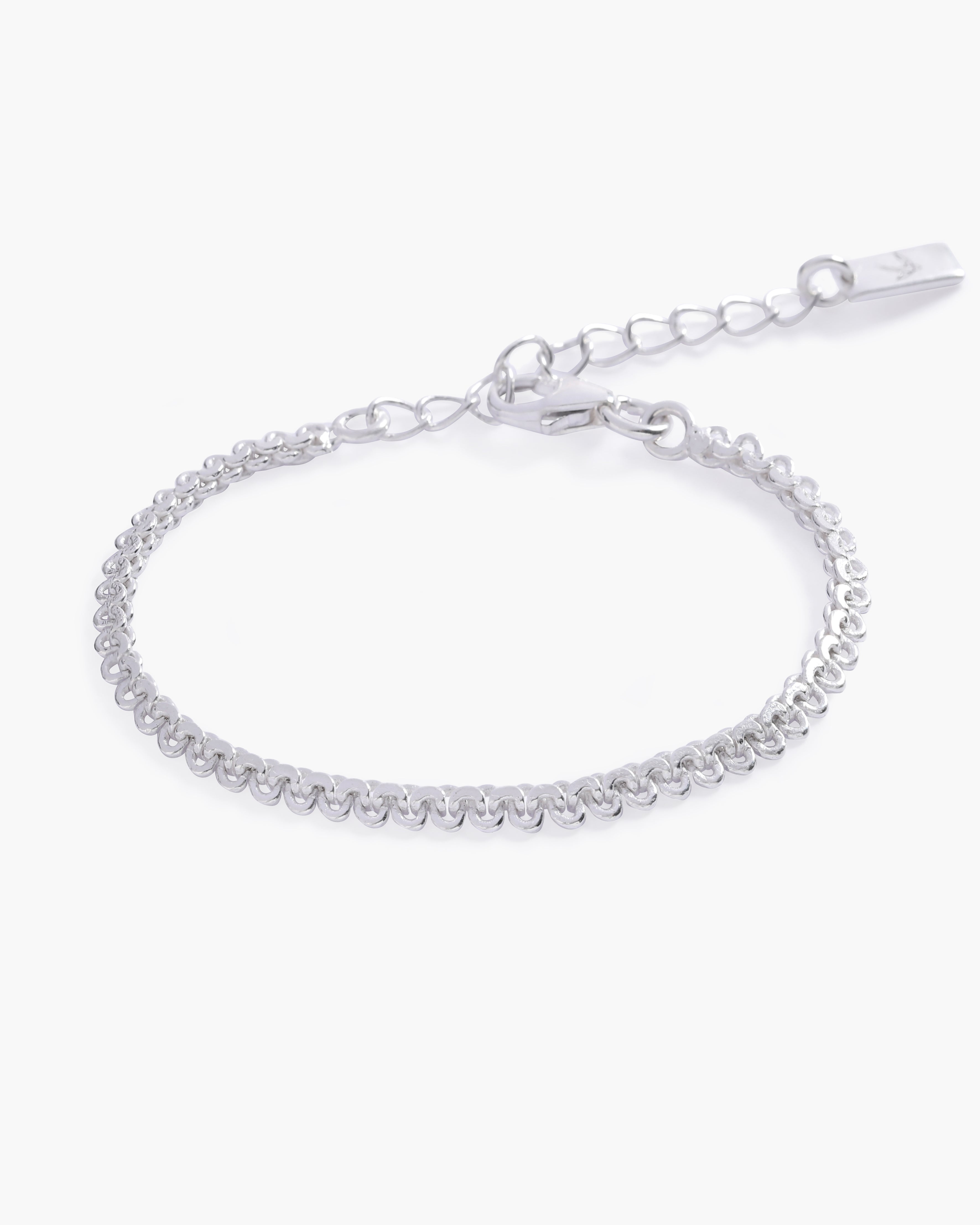 A close-up of The Lace Chain Bracelet, an elegant silver bracelet with delicate lace-like detailing and a refined minimalist design by Bluebird Jewellery