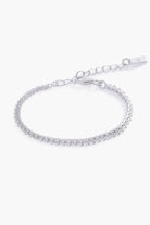 A close-up of The Lace Chain Bracelet, an elegant silver bracelet with delicate lace-like detailing and a refined minimalist design.