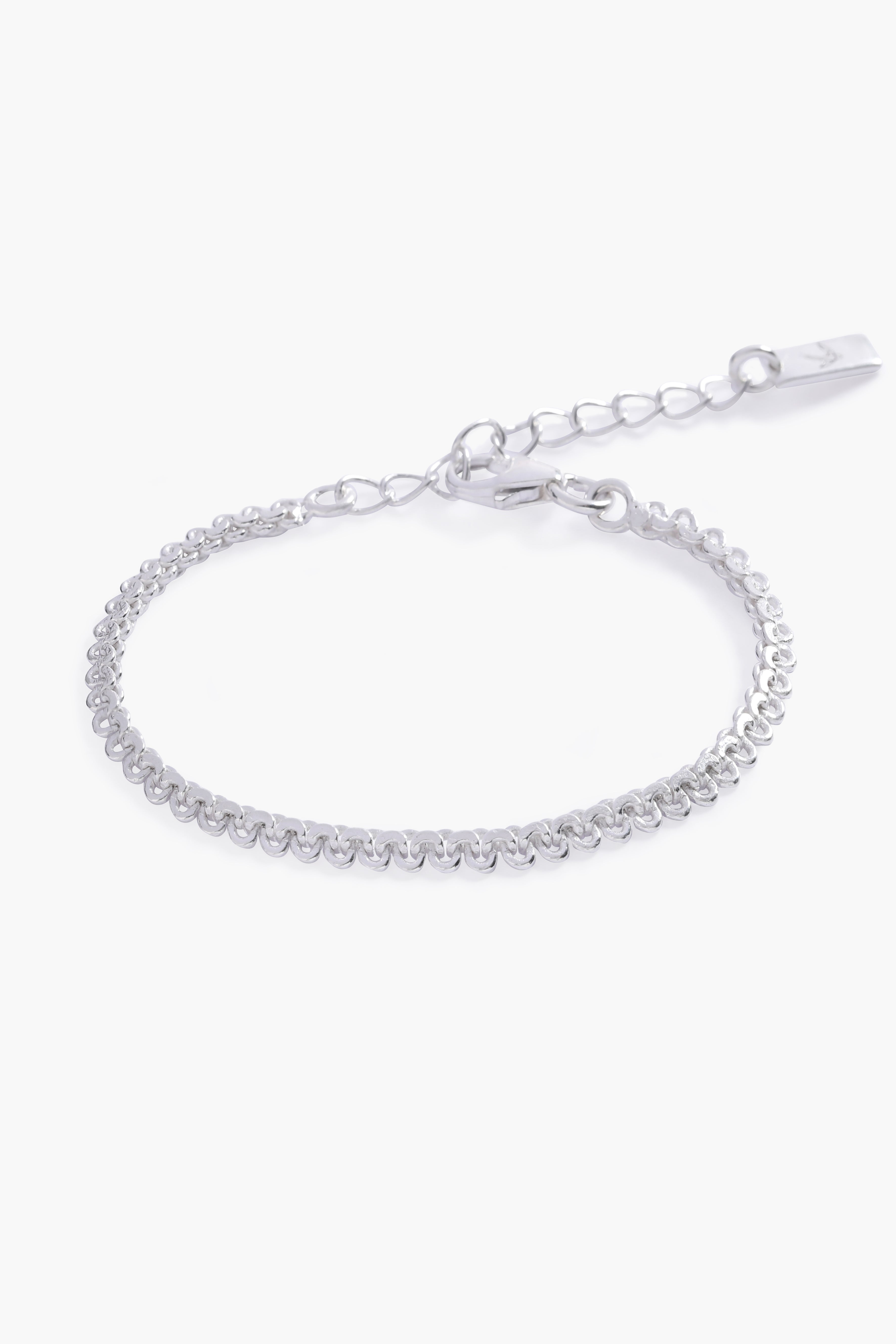 A close-up of The Lace Chain Bracelet, an elegant silver bracelet with delicate lace-like detailing and a refined minimalist design.