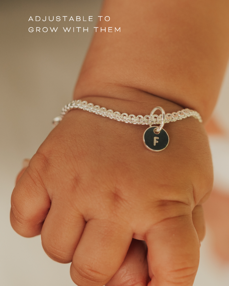 A delicate Lace Chain Bracelet with a heart charm and engraved initial pendant, designed as timeless personalised jewellery by Bluebird Co