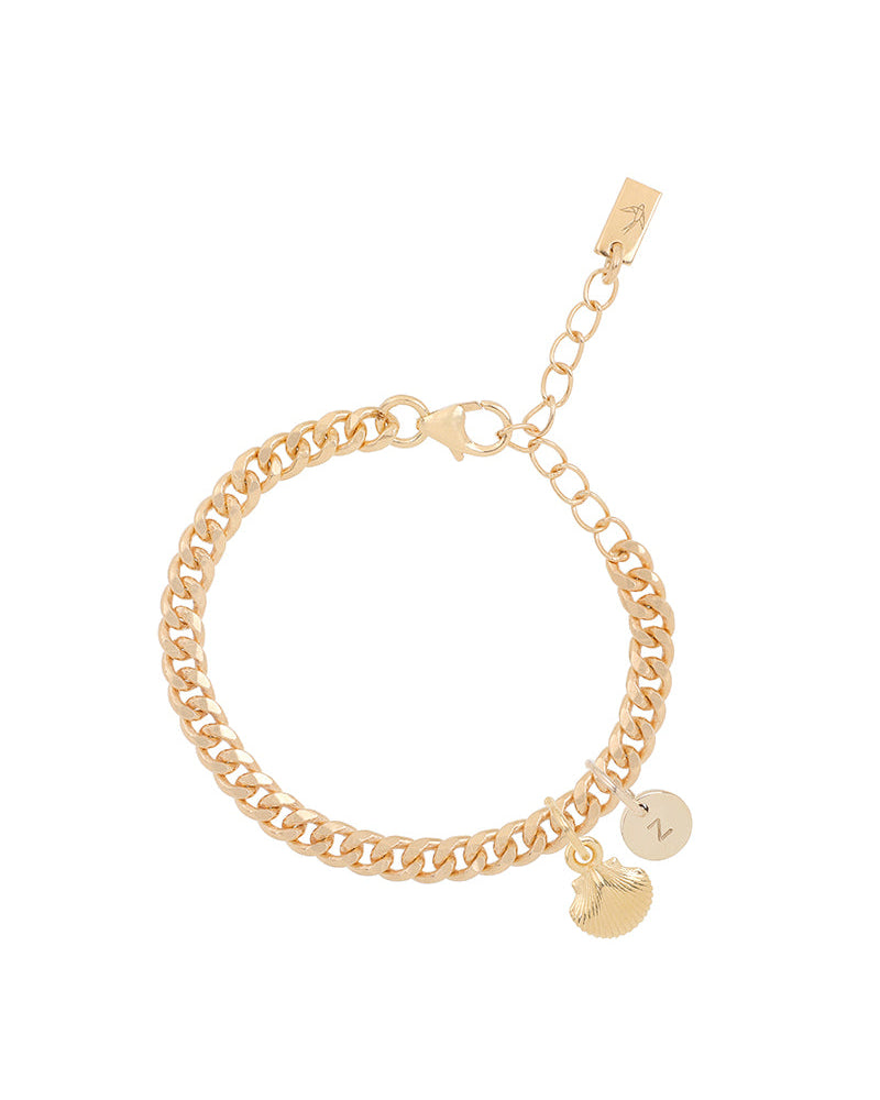 A gold Cuban Link Chain Bracelet featuring a mermaid shell charm and a solid gold initial pendant, crafted as elegant personalised jewellery by Bluebird Co