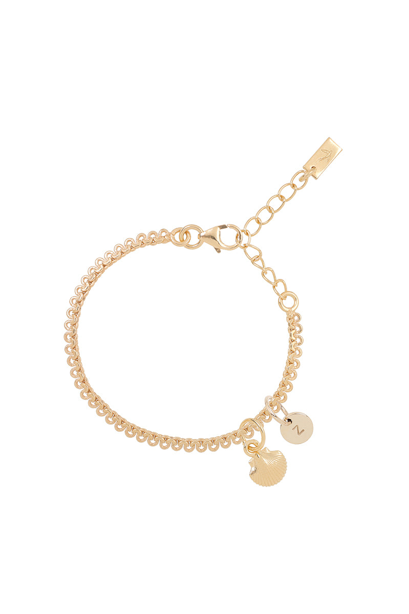 A detailed image of a gold Lace Chain bracelet with a mermaid shell charm and personalised soild gold initial pendant, designed as an elegant and whimsical piece of jewellery by Bluebird Co