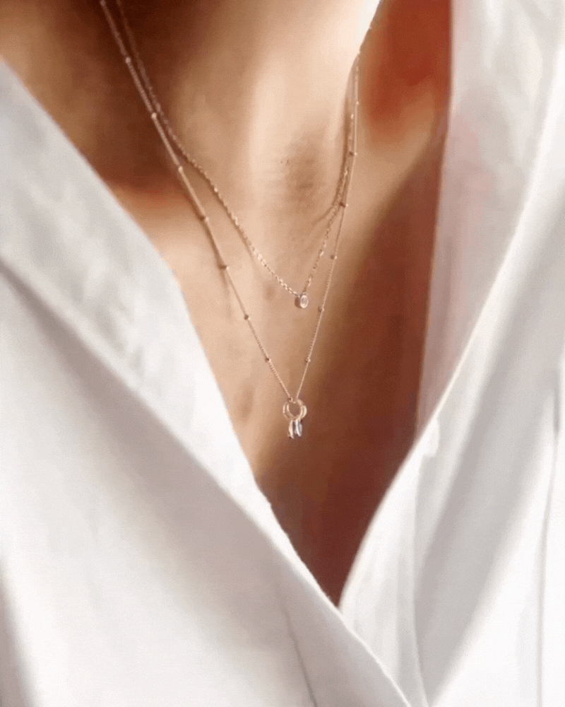 Bluebird Co Lume Necklace Gold layered with the ball chain necklace.