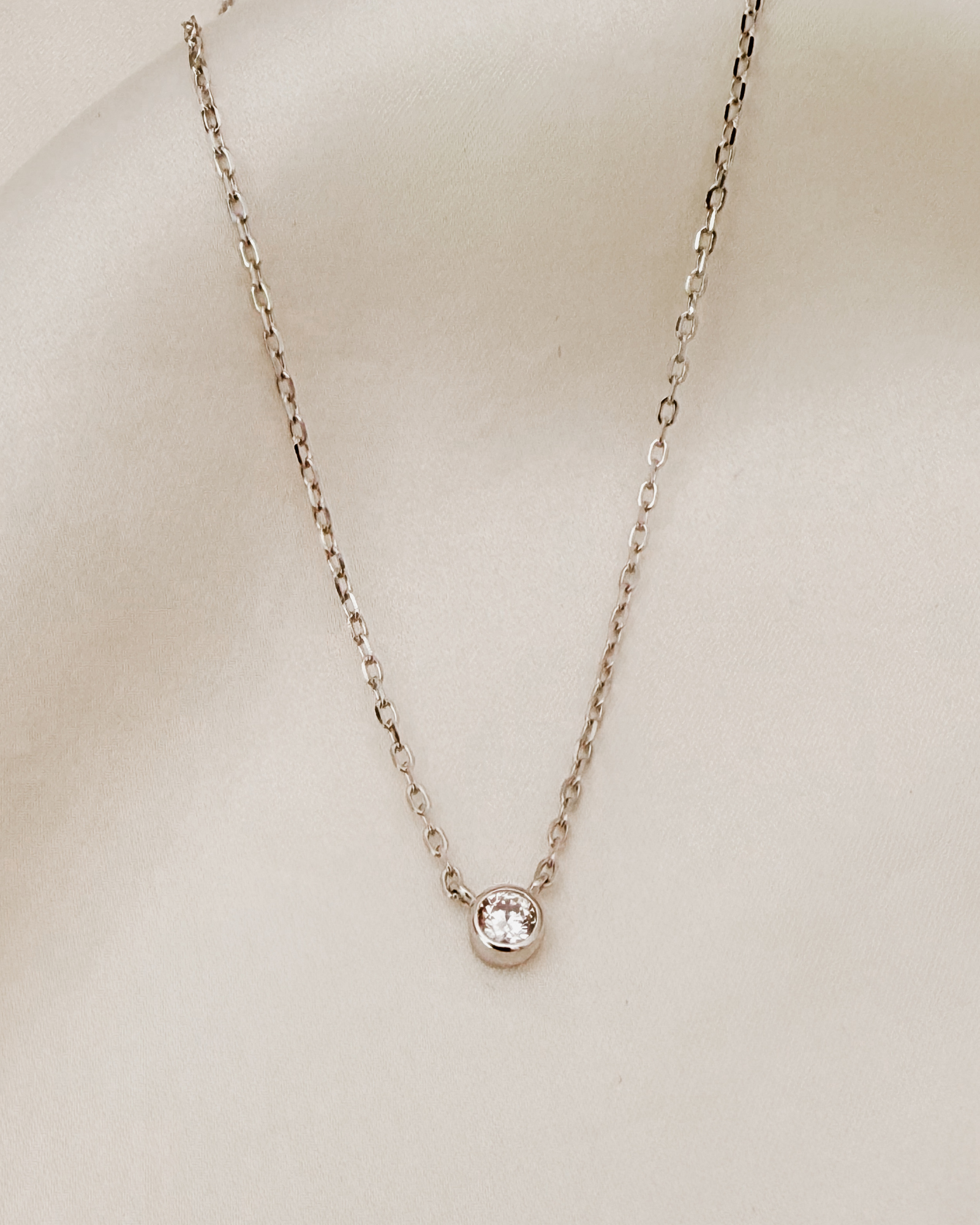 A delicate silver Lumé Necklace by Bluebird Jewellery, designed as a radiant keepsake symbolising light, love, and personal strength.