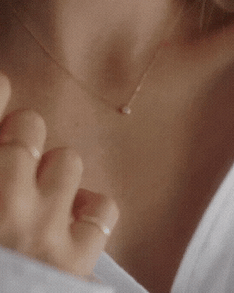 A close-up video of the Lumé Necklace by Bluebird Jewellery, inspired by the French word for ‘light,’ crafted as a radiant symbol of warmth and kindness.