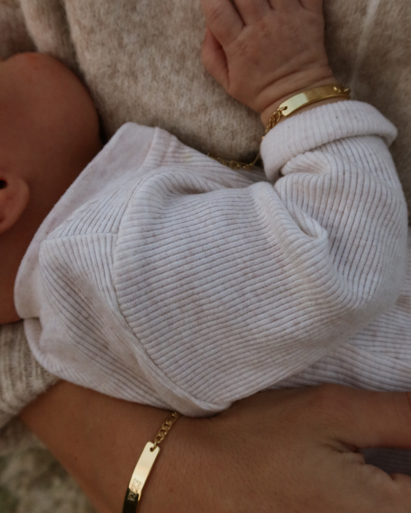 Baby and mum both wearing matching Darling Bracelets in Gold by Bluebird Jewellery.
