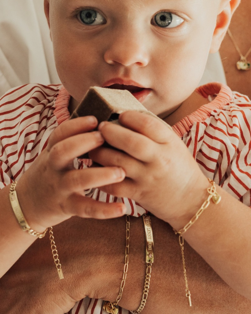A baby holding a Bluebirde Co velbvet gift box whilst wearing matching bracelets with her mum. All bracelets are baby and adult sizes and match.