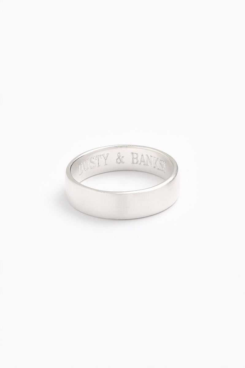 A silver men's ring with a brushed, matte finish, displayed on a white background.