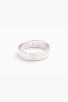 A silver men's ring with a brushed, matte finish, displayed on a white background.