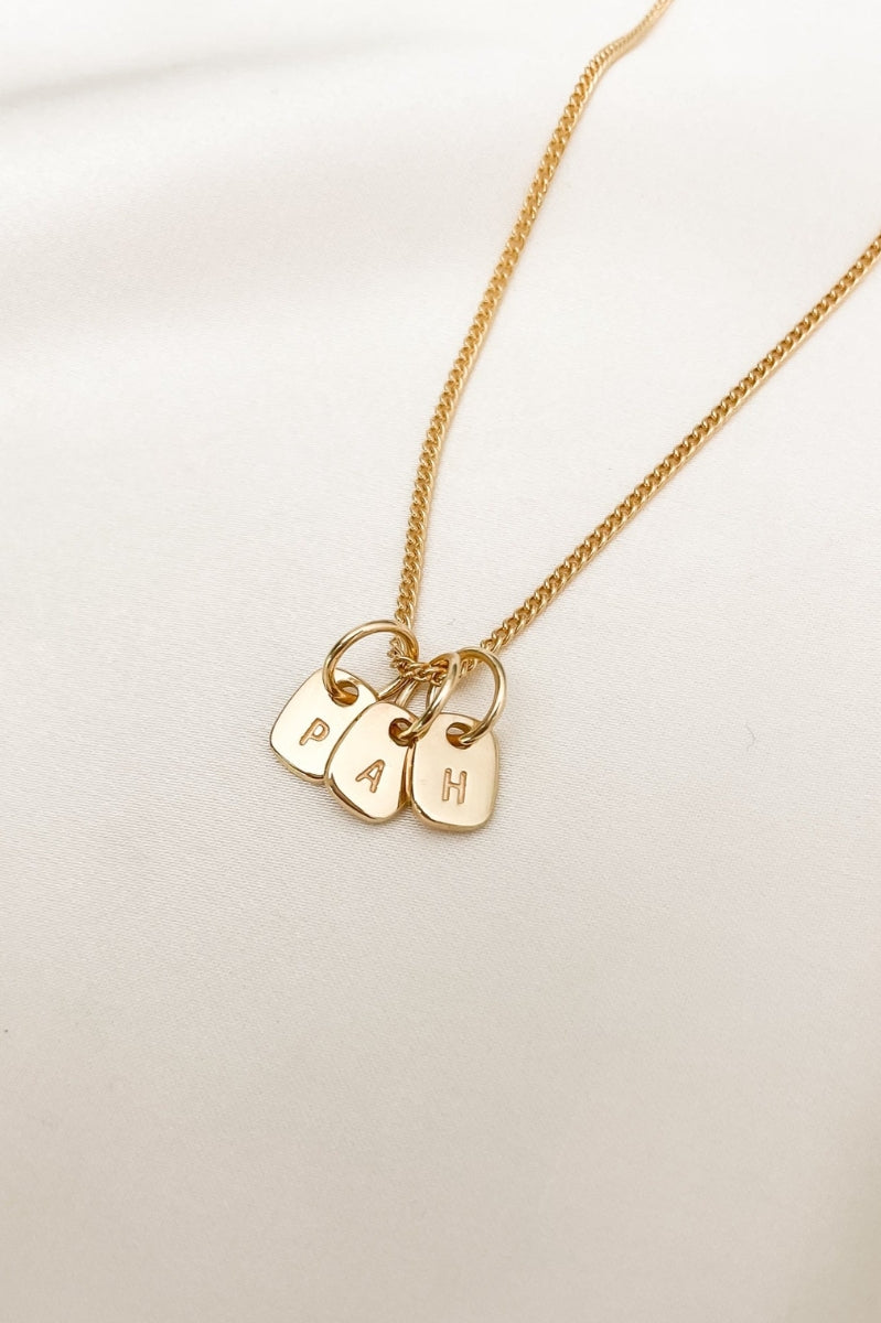 A fine curb chain necklace with the Mini Rectangular Pendants Bluebird Jewellery features gentle curves and a luxe, modern silhouette. Personalised with your chosen letter, it embodies feminine elegance and can be worn beautifully on any necklace, bracelet, or anklet chain.