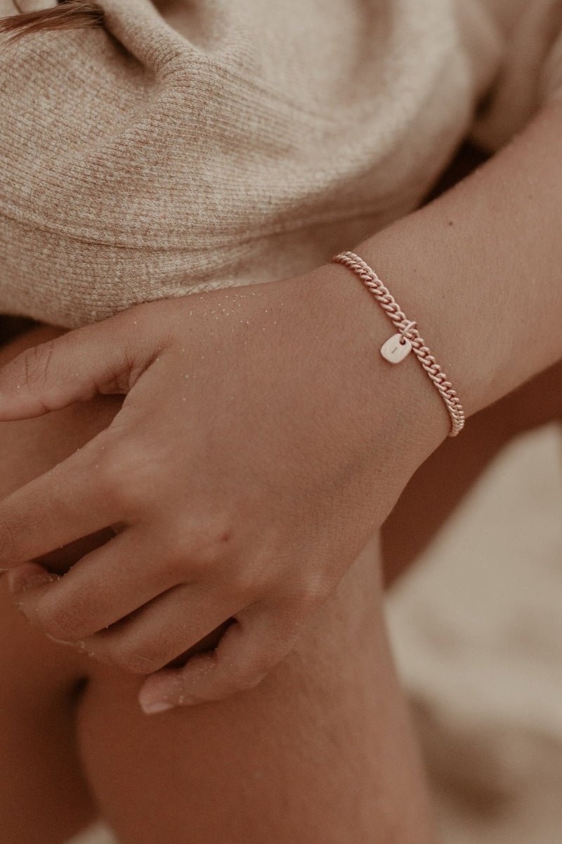 The Mini Rectangular Pendant by Bluebird Jewellery features gentle curves and a luxe, modern silhouette. Personalised with your chosen letter, it embodies feminine elegance and can be worn beautifully on any necklace, bracelet, or anklet chain.