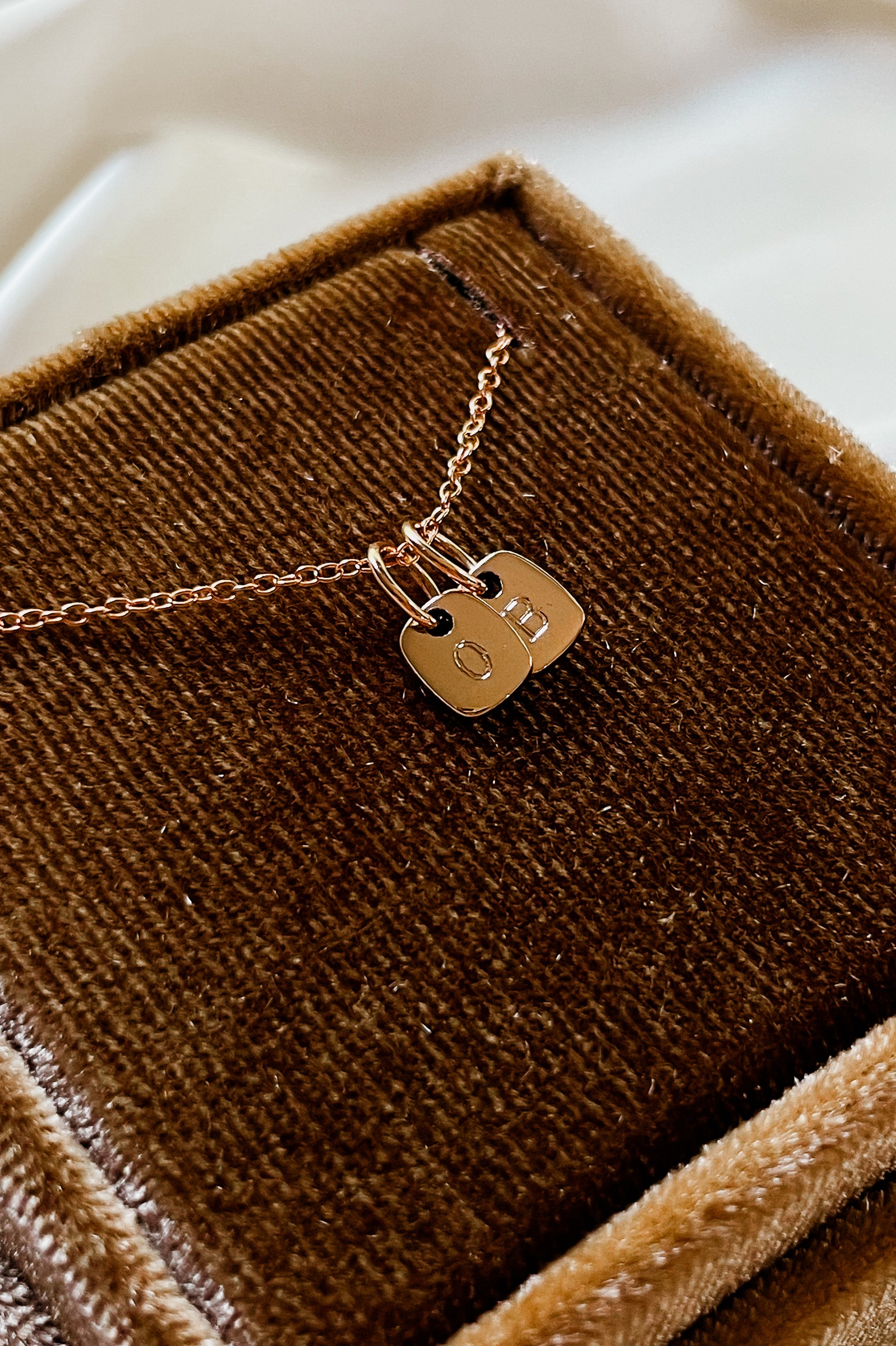 The Mini Rectangular Pendants by Bluebird Jewellery features gentle curves and a luxe, modern silhouette. Personalised with your chosen letter, it embodies feminine elegance and can be worn beautifully on any necklace, bracelet, or anklet chain.