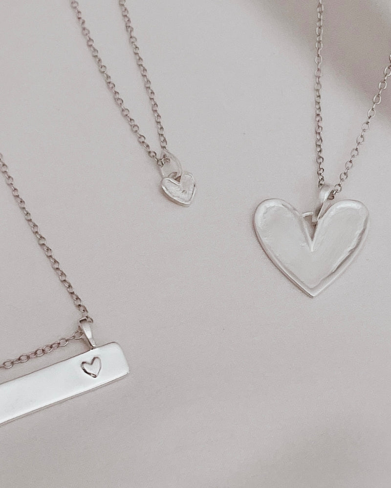 A Darling Bar Necklace, Petite Darling Necklace and Darling Necklace are all shown alongside one another.