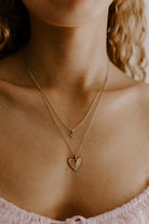 A teenage girl is wearing the Petite Darling Necklace Layered with the Darling Necklace