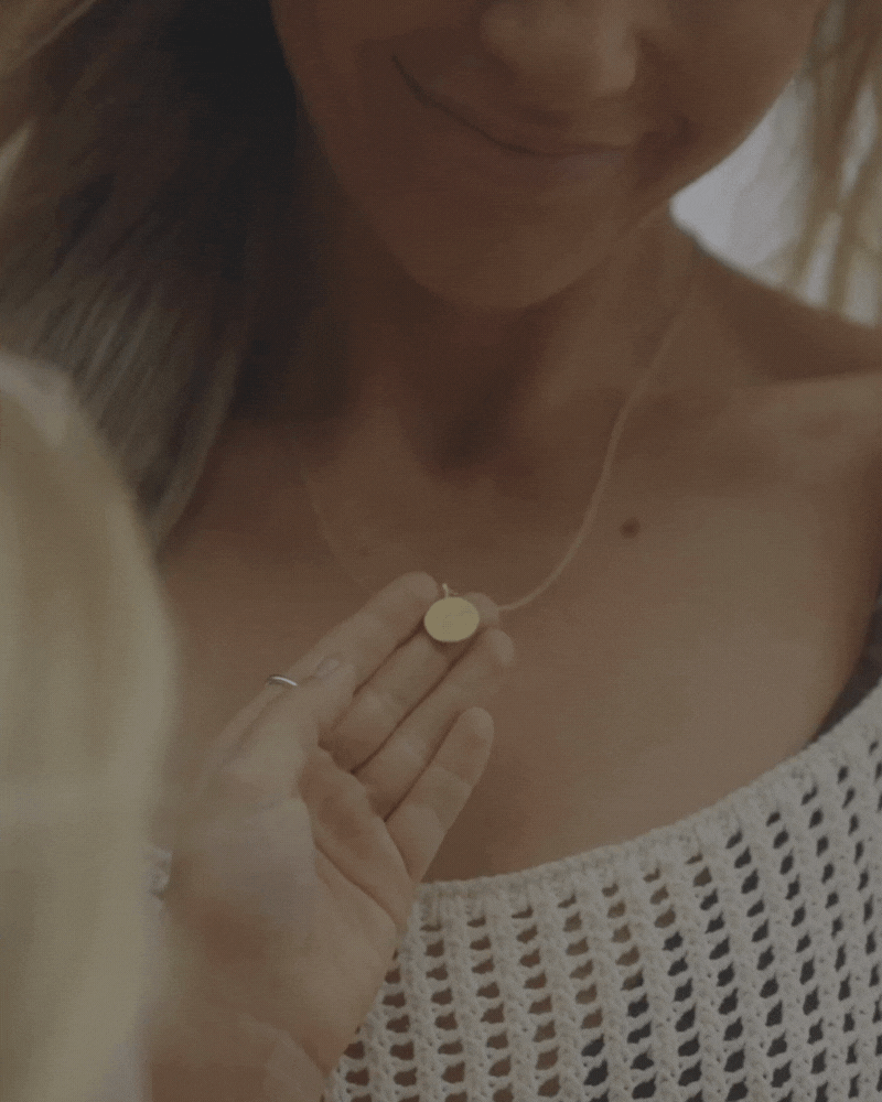 Daughter holding her mother's Petite Signature Necklace