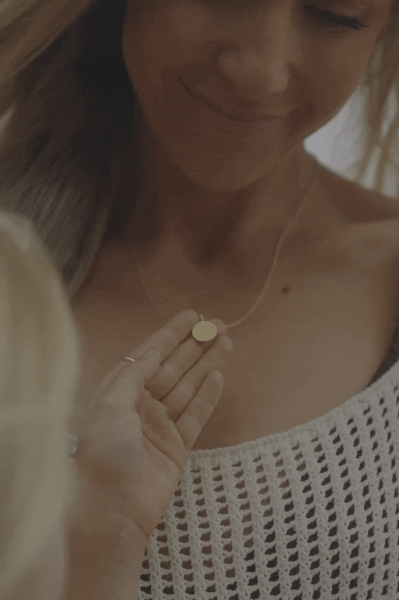 Daughter holding her mother's Petite Signature Necklace