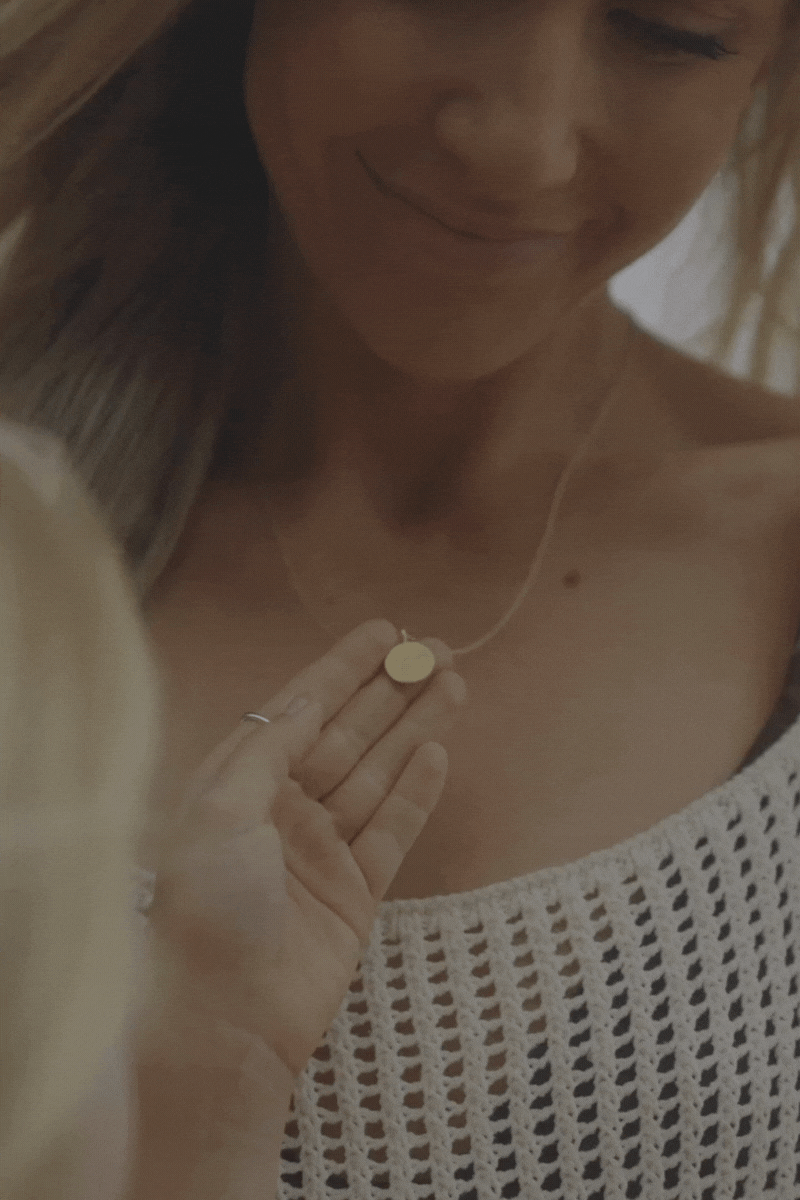 Daughter holding her mother's Petite Signature Necklace
