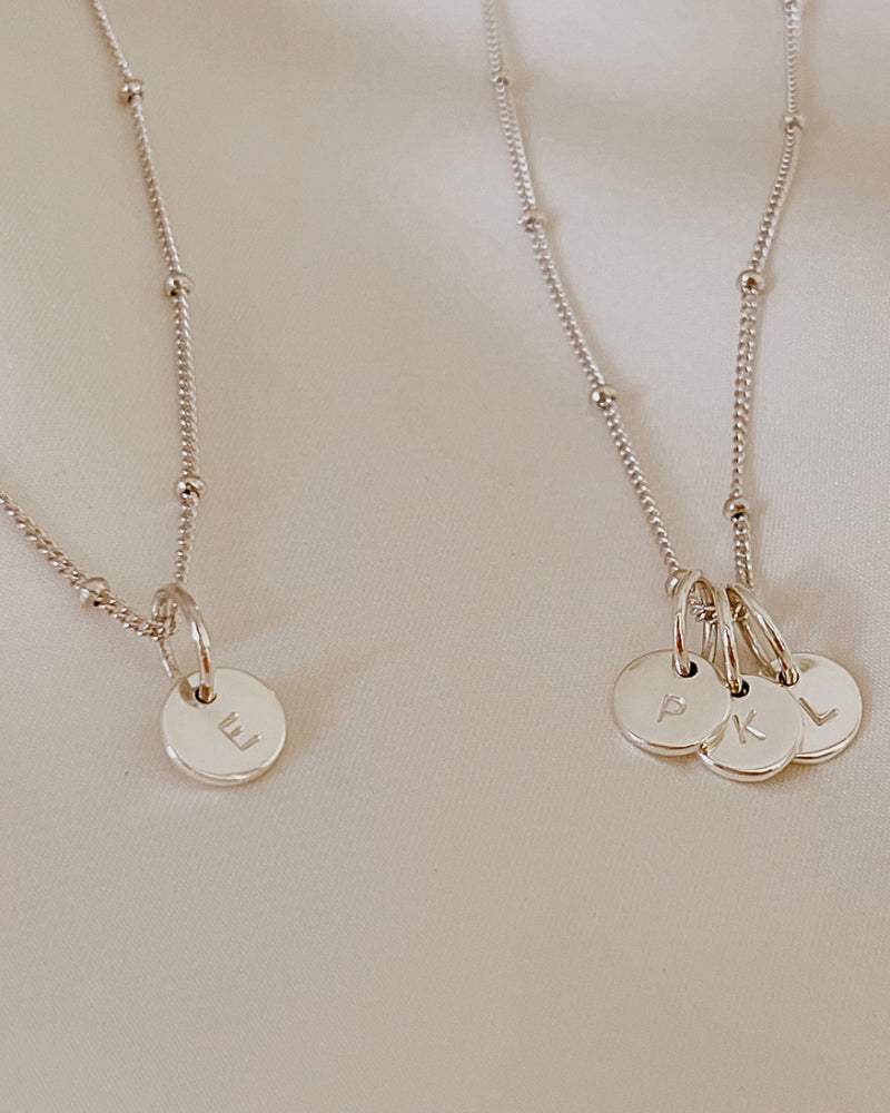 Personalised Initial pendants on a ball chain necklace in matching mum and child necklace lengths.