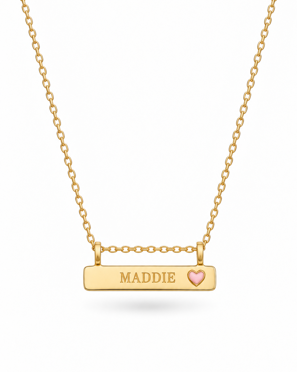 A Bluebird gold bar necklace with a rectangular pendant engraved with the name 'MADDIE' and a small pink heart, suspended from a delicate gold chain on a white background.