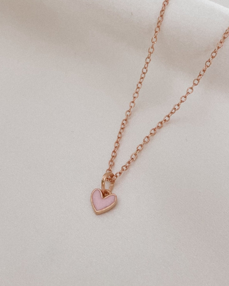 A closer look at the Pink Petite Darling Necklace which shows the small pink heart pendant on the fine cable chain necklace.