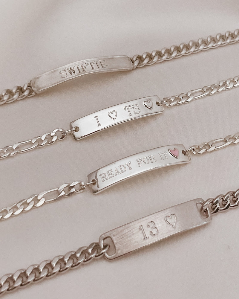 The Pink Darling Bracelet is engraved with 'Ready For It' and features alongside three other engravable bracelet styles. The top bracelet is a Signature Bracelet. The next bracelet is a Darling Bracelet and then a Pink Darling Bracelet and a Classic ID Bracelet by Bluebird Jewellery.