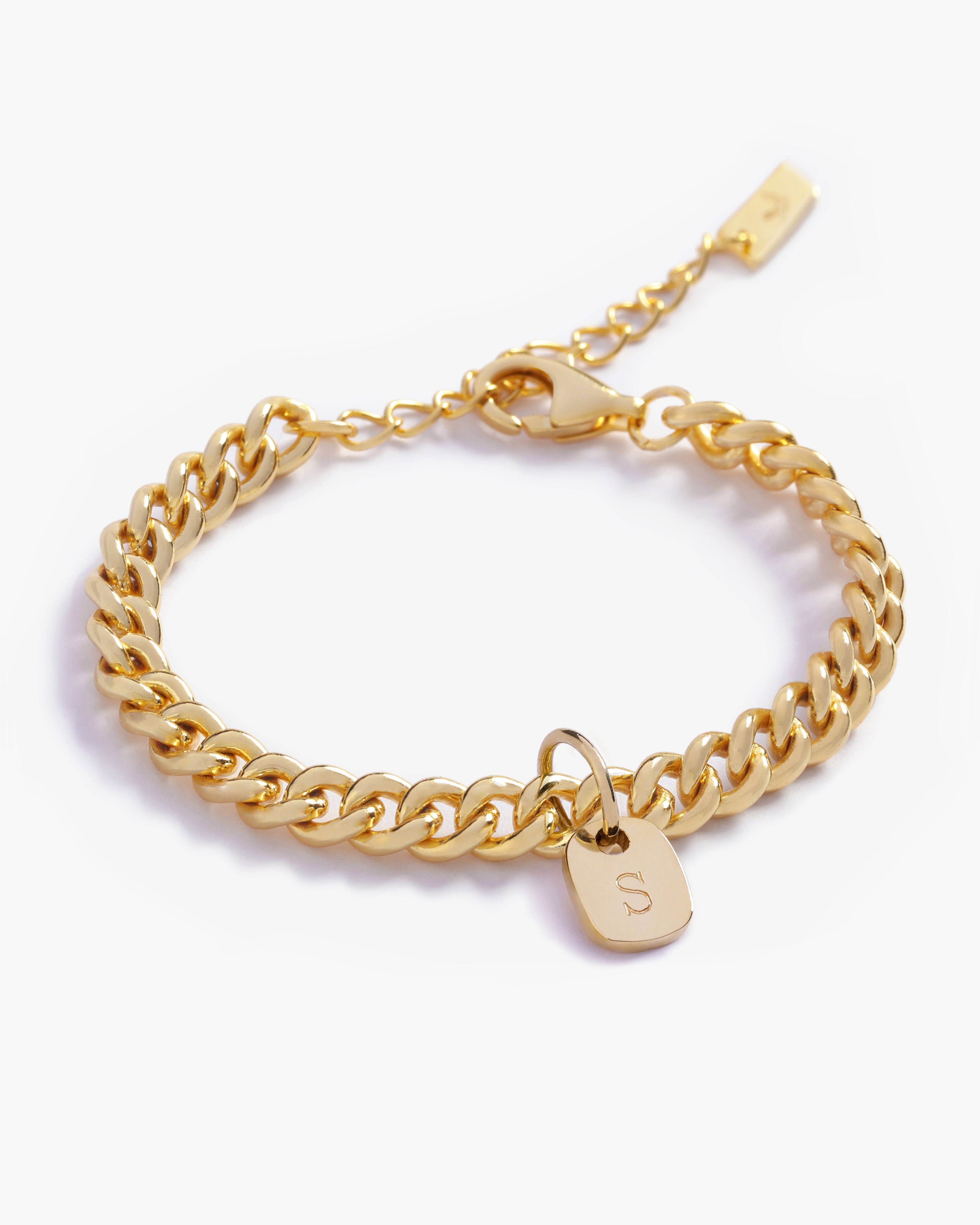 A gold anklet with personalised solid gold initial pendant, beautifully displayed on a white background to highlight its craftsmanship by Bluebird Jewellery