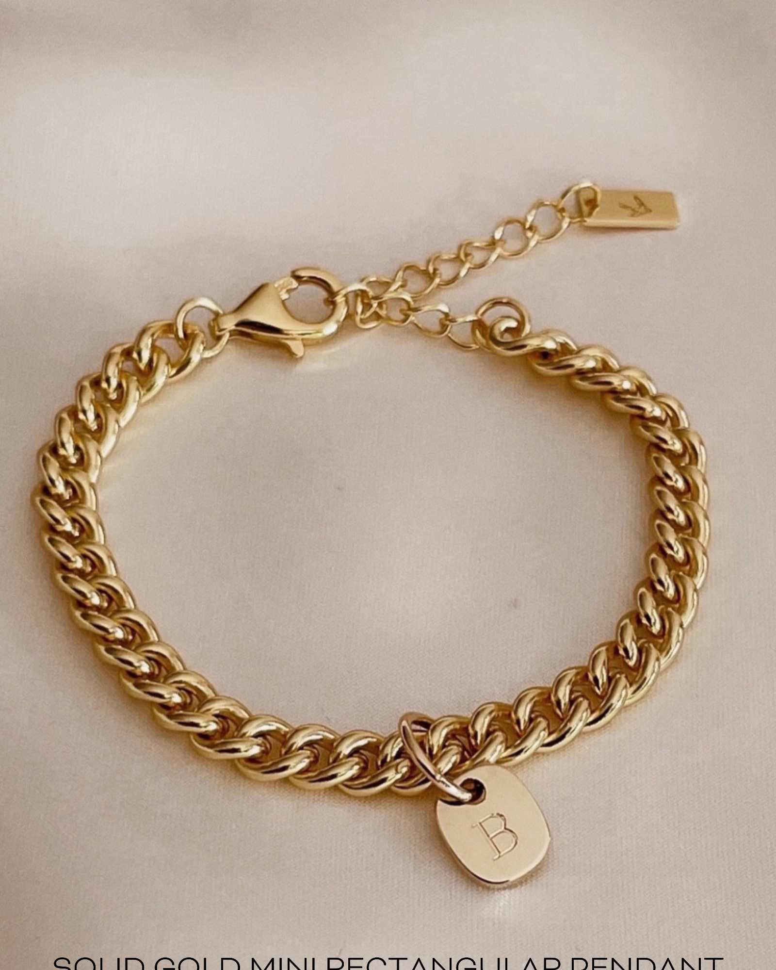 A detailed image of a gold Cuban Link Chain featuring a minimalist soild gold rectangular pendant, crafted in elegant fine jewellery style by Bluebird Co