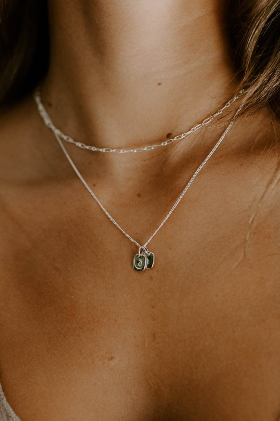 Two Rectangular Initial Pendants are worn on a Fine Curb Chain by Bluebird Jewellery