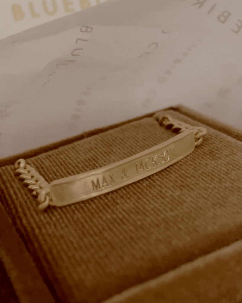Bluebird Co's signature bracelet in gold placed in velvet box.